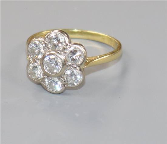 A modern 18ct gold and seven stone diamond flowerhead cluster ring, size P.